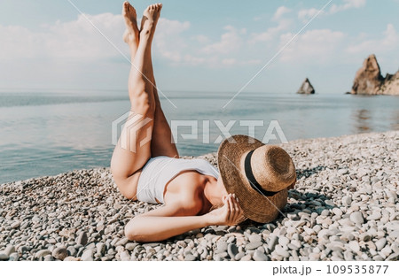 Woman white bikini beach tan. Happy woman in swimwear and hat on vacation. Summer travel holidays vacation on the sea Woman white bikini beach tan. Happy woman in swimwear and hat on vacation. Summer travel holidays vacation on the sea 109535877