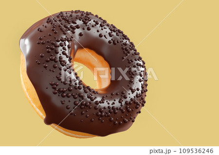 Chocolate glazed donut with sprinkles on a yellow background 109536246