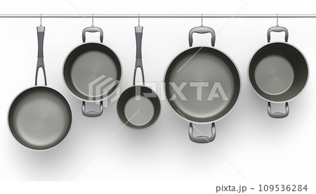 Set of stewpot, frying pan and chrome plated cookware hanging on shelf on white 109536284