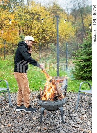 A man lights a barbecue in nature 109536754