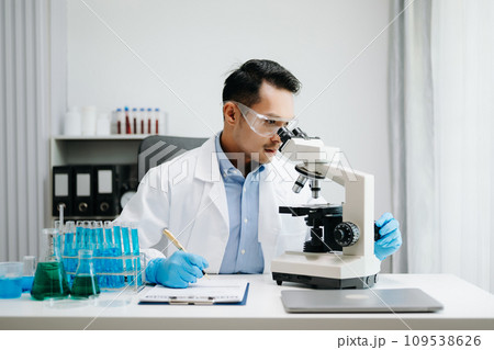 Modern medical research laboratory. male scientist working with micro pipettes analyzing biochemical samples, advanced science chemical laboratory medicine. Modern medical research laboratory. male scientist working with micro pipettes analyzing biochemical samples, advanced science chemical laboratory medicine. 109538626