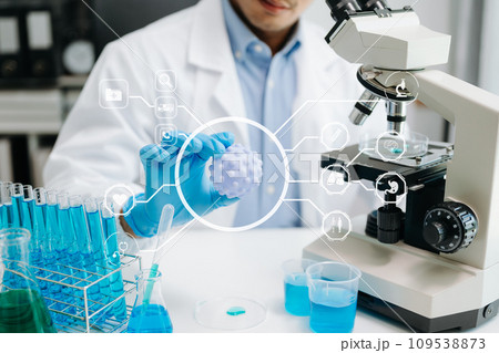 Healthcare professional holding Coronavirus COVID 19 vaccine in laboratory study and analyze scientific sample of Coronavirus antibody in lab. Healthcare professional holding Coronavirus COVID 19 vaccine in laboratory study and analyze scientific sample of Coronavirus antibody in lab. 109538873