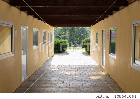 Indoor enclosures for animals in a zoo with windows for observation by tourists. No people. Warm pens for animals at the zoo. Special windows allow tourists to observe the animals. 109541061