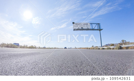 Embarking on a road trip from Nevada to California, driving on Highway 15 during the day offers scenic views and an exciting journey between states. 109542631