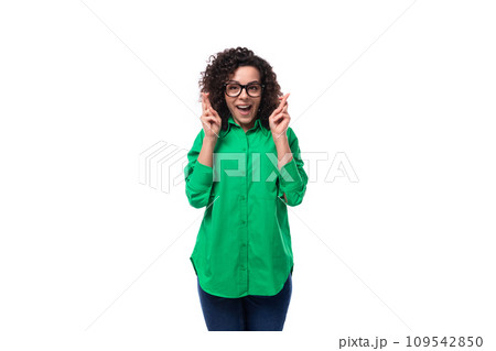 young positive secretary brunette woman with curly hair dressed in a green blouse crossed her young positive secretary brunette woman with curly hair dressed in a green blouse crossed her 109542850
