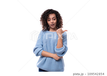 young curly brunette woman dressed in a blue sweater is brainstorming 109542854