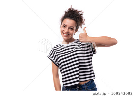 young joyful caucasian woman with curly black hair is dressed in a striped black and white t-shirt young joyful caucasian woman with curly black hair is dressed in a striped black and white t-shirt 109543092