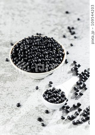Black beans on gray background Black beans on gray background 109544203