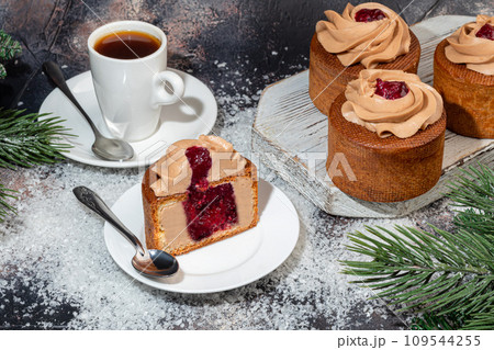 Cakes filled with cream and cherry jam. Box eclairs. New Year and holiday concept. Cakes filled with cream and cherry jam. Box eclairs. New Year and holiday concept. 109544255