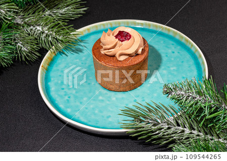 Cakes filled with cream and cherry jam. Box eclairs. New Year and holiday concept. Cakes filled with cream and cherry jam. Box eclairs. New Year and holiday concept. 109544265