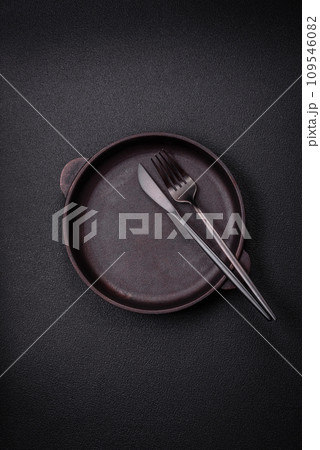 Bumpy empty ceramic plate on a textured concrete background 109546082