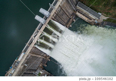 Aerial top down view of water discharge at hydroelectric power plant Aerial top down view of water discharge at hydroelectric power plant 109546102