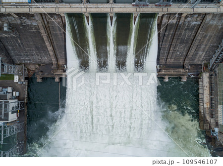 Aerial top down view of water discharge at hydroelectric power plant 109546107
