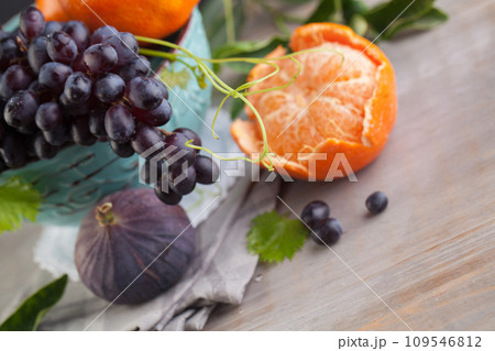 Blue grape, orange tangerine, figs fruit mix, healthy food background Blue grape, orange tangerine, figs fruit mix, healthy food background 109546812