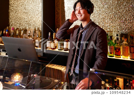 ミキサーで音楽を演奏する若い男性DJ ミキサーで音楽を演奏する若い男性DJ 109548234