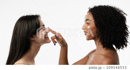 Female models of various ages celebrating their natural bodies in a studio. Two confident and joyful women smiling radiantly, having used cosmetics. Female models of various ages celebrating their natural bodies in a studio. Two confident and joyful women smiling radiantly, having used cosmetics. 109548553