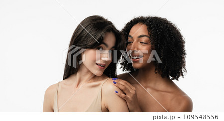 Female models of various ages celebrating their natural bodies in a studio. Two confident and joyful women smiling radiantly, having used cosmetics. Female models of various ages celebrating their natural bodies in a studio. Two confident and joyful women smiling radiantly, having used cosmetics. 109548556