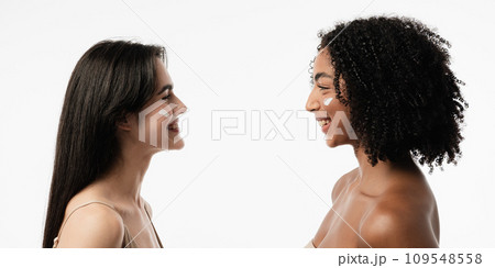 Female models of various ages celebrating their natural bodies in a studio. Two confident and joyful women smiling radiantly, having used cosmetics. 109548558