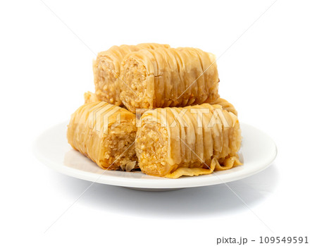 Rolled Baklava Isolated, Ramadan Dessert Roll on Restaurant Plate, Eastern Sweet Pastries Rolled Baklava Isolated, Ramadan Dessert Roll on Restaurant Plate, Eastern Sweet Pastries 109549591