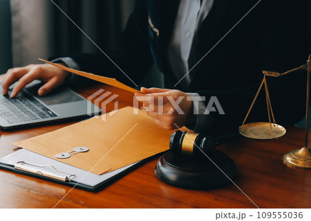 Business and lawyers discussing contract papers with brass scale on desk in office. Law, legal services, advice, justice and law concept picture with film grain effect 109555036