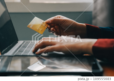 Close up of woman hand using credit card and laptop for payment and online shopping, Online shopping, payments digital banking, E-commerce concept. 109555083