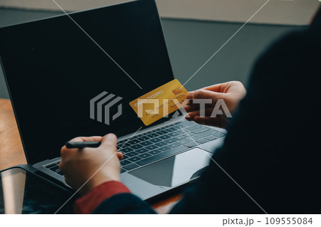 Close up of woman hand using credit card and laptop for payment and online shopping, Online shopping, payments digital banking, E-commerce concept. Close up of woman hand using credit card and laptop for payment and online shopping, Online shopping, payments digital banking, E-commerce concept. 109555084