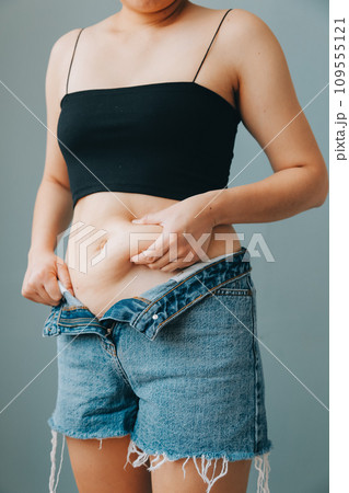 fat woman, fat belly, chubby, obese woman hand holding excessive belly fat with measure tape, woman diet lifestyle concept fat woman, fat belly, chubby, obese woman hand holding excessive belly fat with measure tape, woman diet lifestyle concept 109555121