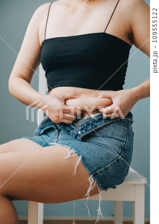 fat woman, fat belly, chubby, obese woman hand holding excessive belly fat with measure tape, woman diet lifestyle concept fat woman, fat belly, chubby, obese woman hand holding excessive belly fat with measure tape, woman diet lifestyle concept 109555122
