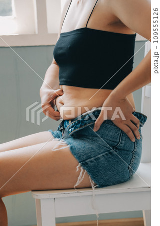 fat woman, fat belly, chubby, obese woman hand holding excessive belly fat with measure tape, woman diet lifestyle concept 109555126