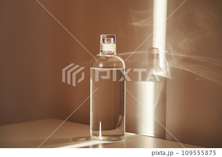 A bottle of clean drinking water in a ray of morning sun. A bottle of clean drinking water in a ray of morning sun. 109555875