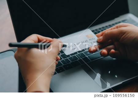 Women holding credit card and using smartphones at home.Online shopping, internet banking, store online, payment, spending money, e-commerce payment at the store, credit card, concept Women holding credit card and using smartphones at home.Online shopping, internet banking, store online, payment, spending money, e-commerce payment at the store, credit card, concept 109556150