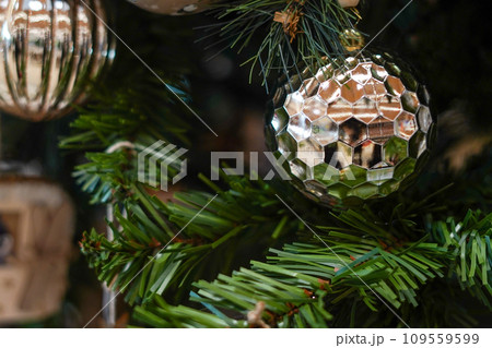 Christmas background - silver ball on the branch of spruce tree Christmas background - silver ball on the branch of spruce tree 109559599