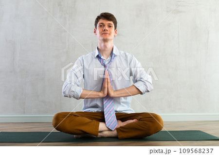 Young guy office worker doing yoga in studio 109568237