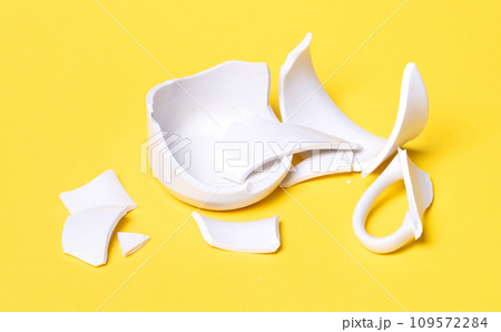 Broken cup isolated on a solid background Broken cup isolated on a solid background 109572284