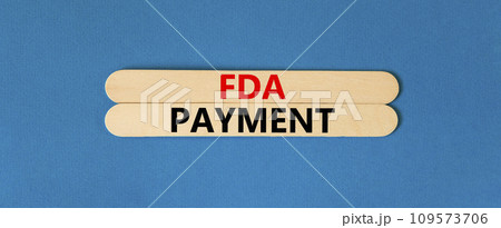 FDA Food and Drug Administration payment symbol. Concept words FDA payment on beautiful wooden stick. Beautiful blue table blue background. Business FDA payment concept. Copy space. FDA Food and Drug Administration payment symbol. Concept words FDA payment on beautiful wooden stick. Beautiful blue table blue background. Business FDA payment concept. Copy space. 109573706