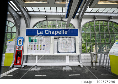Paris, France. July 1, 2022. La Chapelle metro stop. POV from inside the train. Charming vintage look for this elevated station. 109575296