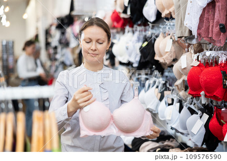 Adult woman choosing bra in store Adult woman choosing bra in store 109576590