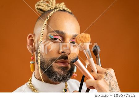 Latino gay make up artist holding makeup brush 109577815