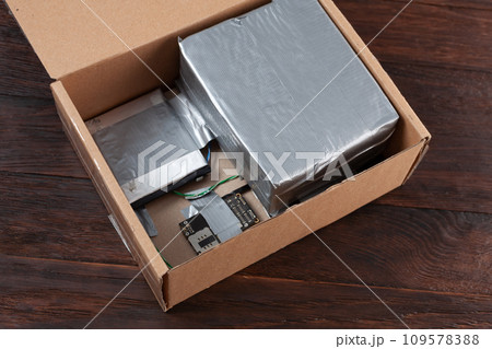 Hand made bomb with c4 and cell phone module in a cardboard box 109578388