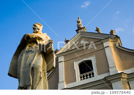 Kamianets-Podilskyi, , Ukraine, 2006. Stone statue of a Catholic saint in front of the Holy Trinity Church of Trinitarian Order. Kamianets-Podilskyi, , Ukraine, 2006. Stone statue of a Catholic saint in front of the Holy Trinity Church of Trinitarian Order. 109578440
