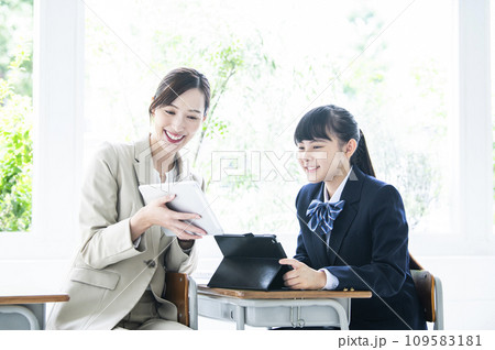 タブレットPCで勉強する女子中学生と女性教員 タブレットPCで勉強する女子中学生と女性教員 109583181