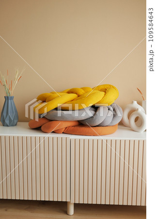 single orange color pillow on a decorative table single orange color pillow on a decorative table 109584643