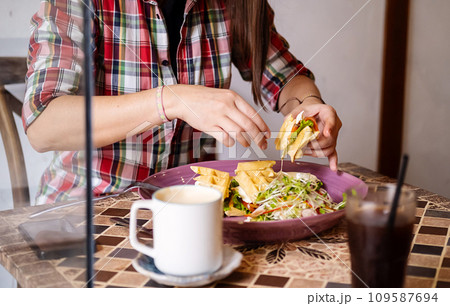 Caucasian woman in casual clothes having lunch in cafe. 109587694