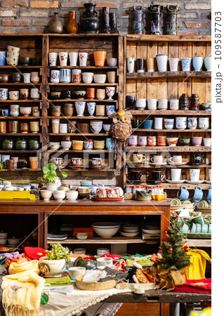 Small store with many pottery ceramic standing on shelves. Small store with many pottery ceramic standing on shelves. 109587703