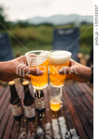 Beer on the table and camping party,hands toasting in beer, 109588897
