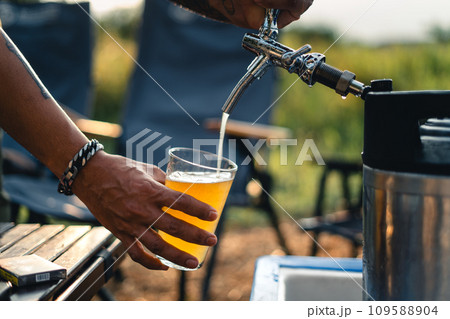 Beer on the table and camping party,hands toasting in beer, Beer on the table and camping party,hands toasting in beer, 109588904