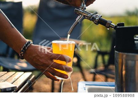 Beer on the table and camping party,hands toasting in beer, 109588908