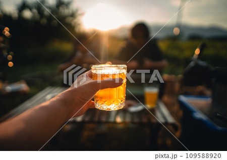 Beer on the table and camping party,hands toasting in beer, Beer on the table and camping party,hands toasting in beer, 109588920