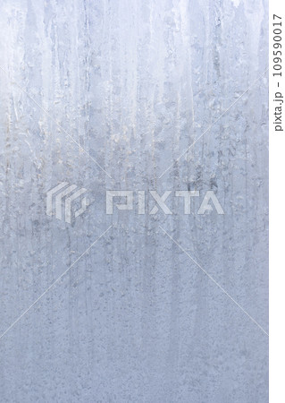 Frosty winter striped pattern on winter window glass. Magic of nature. Vertical image. Copy space. Frosty winter striped pattern on winter window glass. Magic of nature. Vertical image. Copy space. 109590017