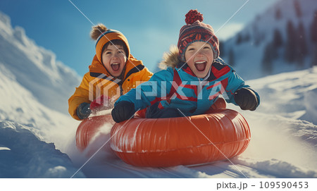 AI-generated content. Two very happy kids sliding down a snowy slope on inflatable tubing 109590453
